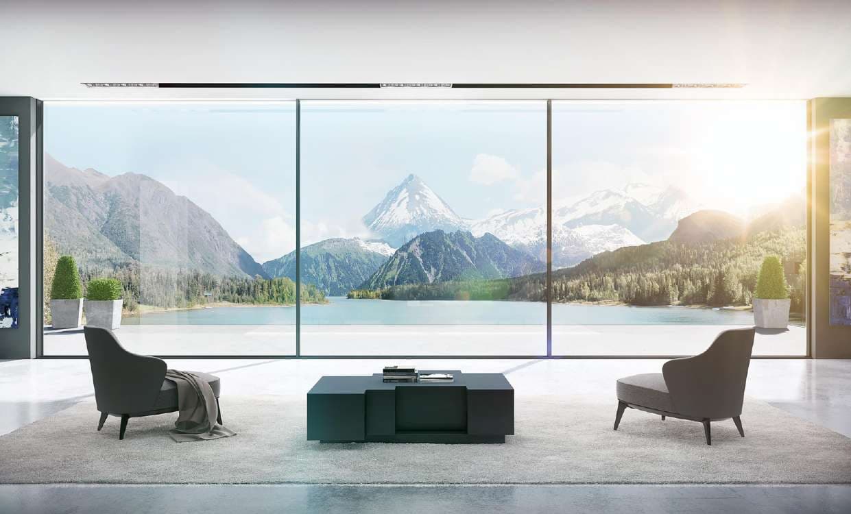 Aluminium sliding doors opening a living room onto a lake and mountains